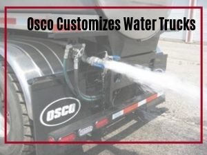 Water spraying from a nozzle on an Osco Tank and Truck Sales water truck